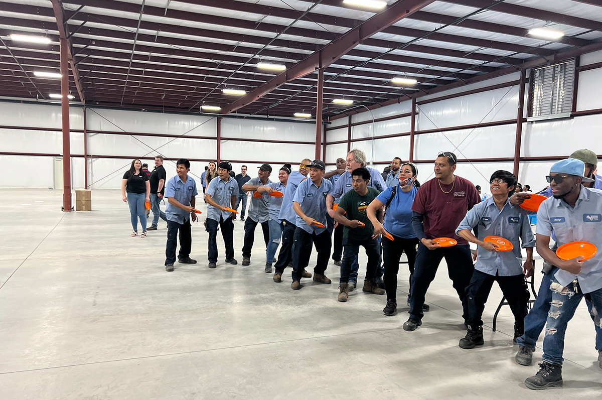 Nordfab employees throwing frisbees